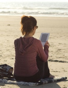 Girl on the beach with Kindle
