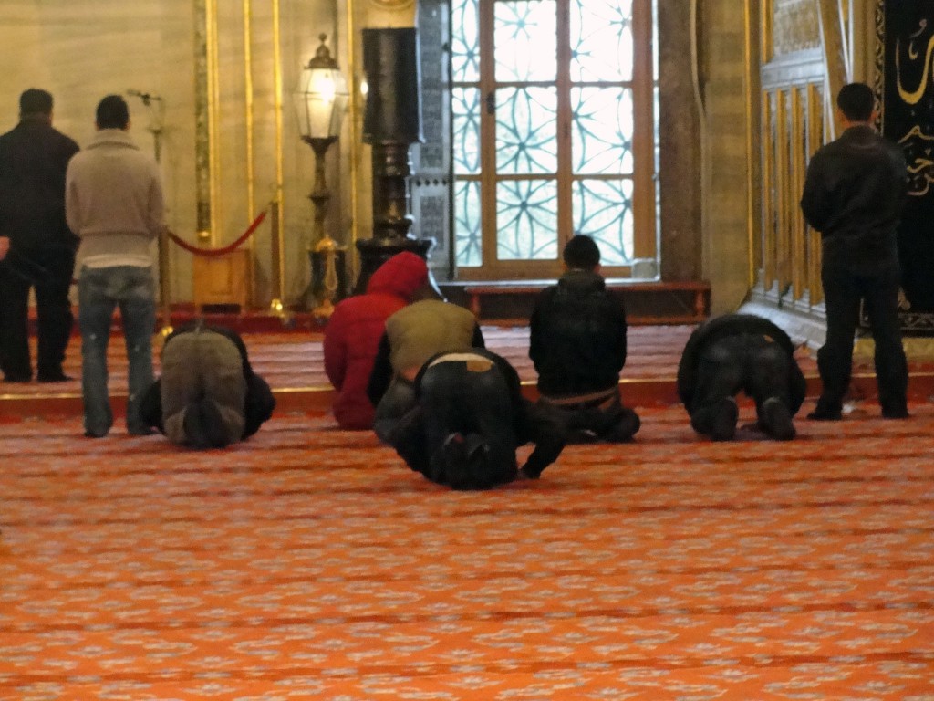 Men praying at Blue Mosque